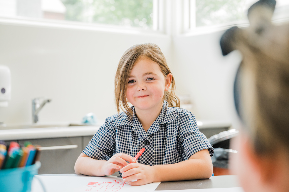 child-with-red-texta Child with red texta in classroom.